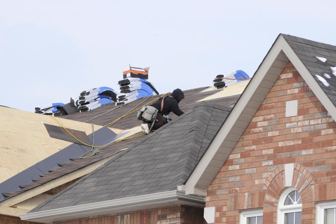 A contractor replacing a roof in Elgin