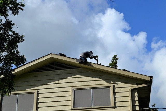 A man in Elgin IL repairing a roof
